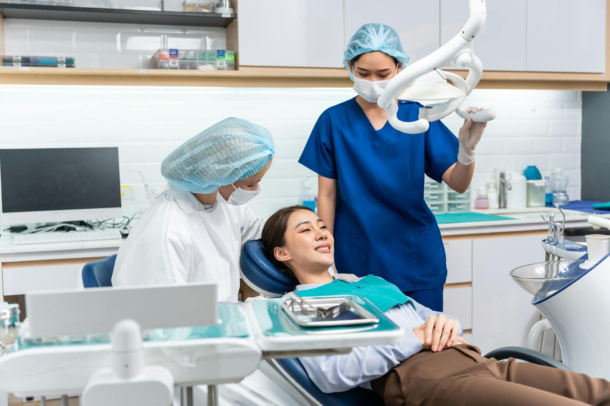 Caucasian dentist examine tooth for young girl at dental health clinic.